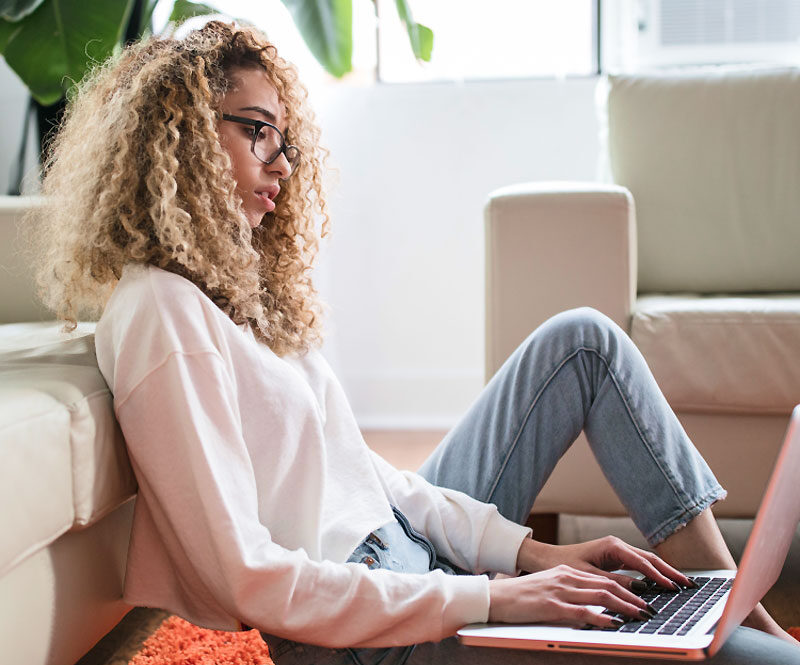 Woman Sitting on Floor Working